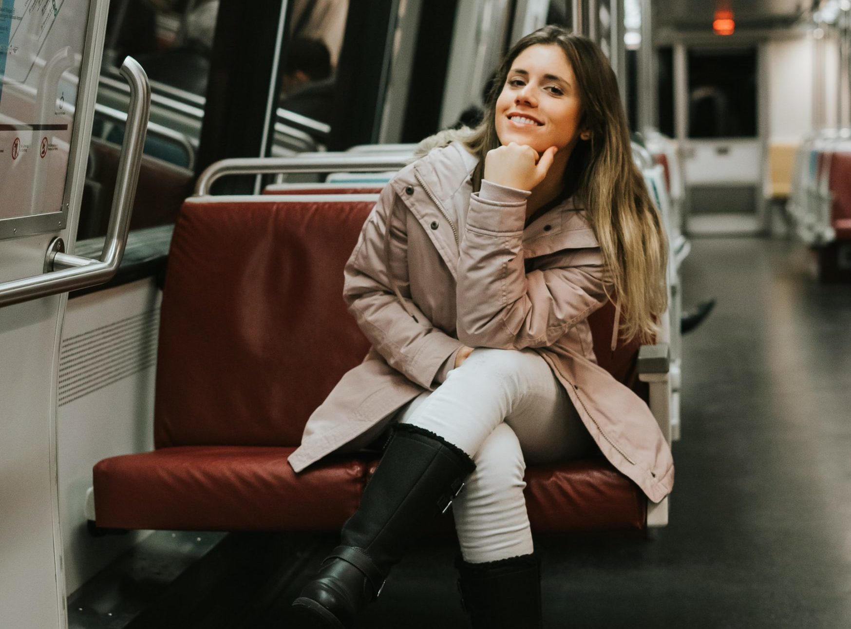 Young woman riding on a train.