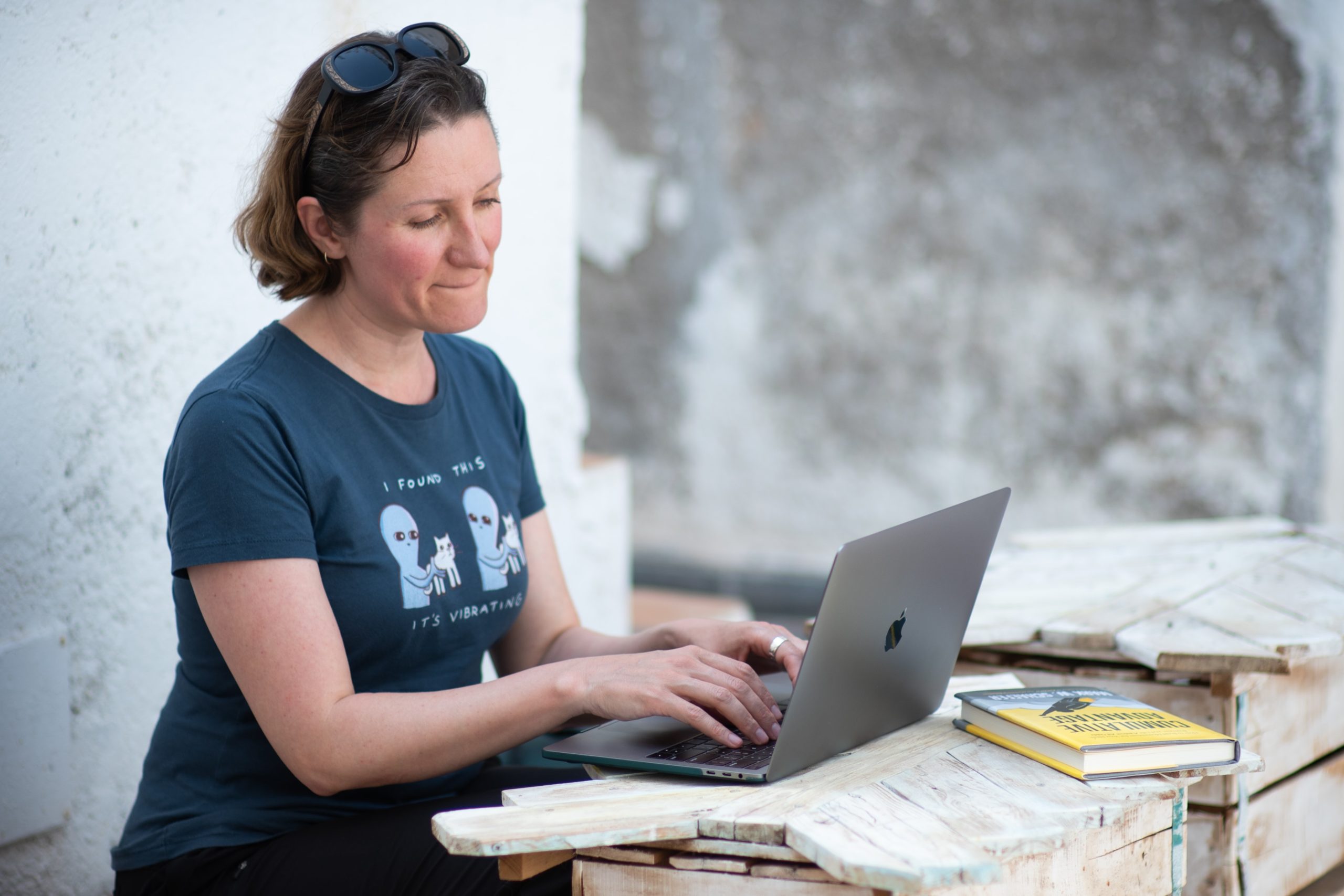 Woman working on a laptop on an outdoor terrace