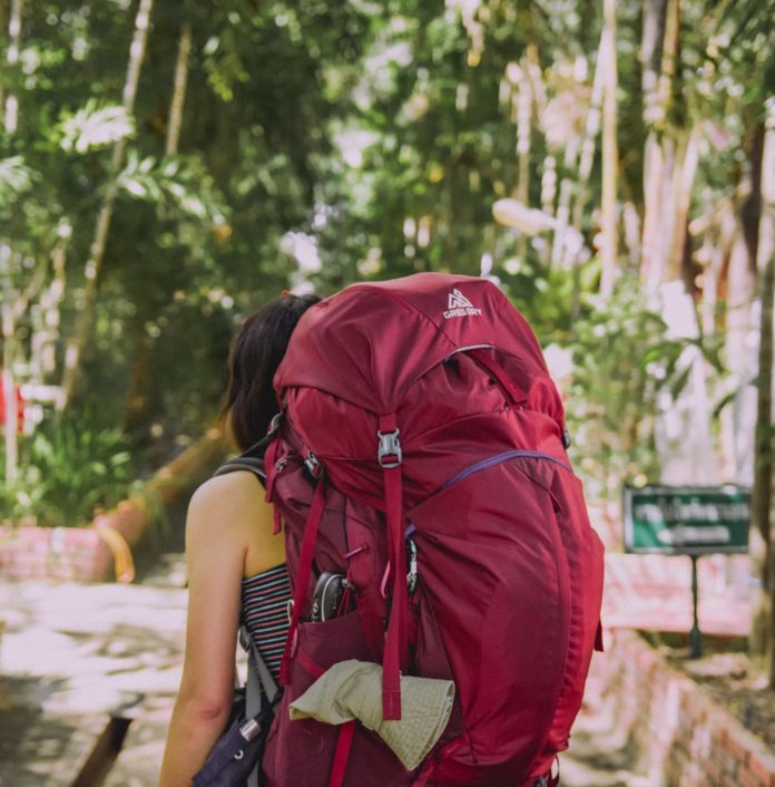 Person with red backpack