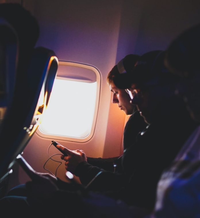 Passenger listening to music on plane