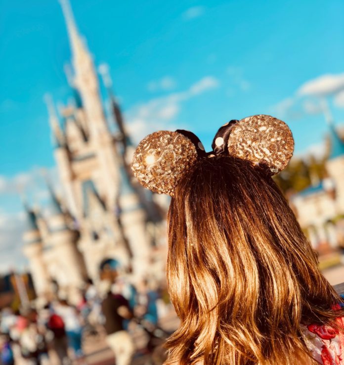 Woman wearing Mickey Mouse ears in Disney