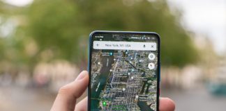 Hand holding phone with google maps