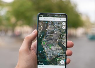 Hand holding phone with google maps