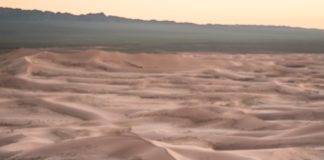 Woman meditating in desert
