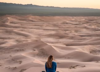 Woman meditating in desert
