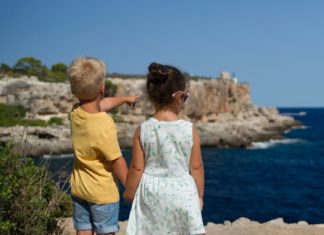 Two children standing near cliff