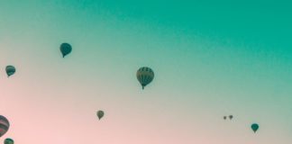 Woman looking at hot air balloons