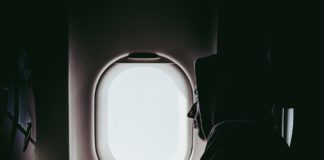 Man sleeping by plane window