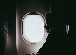 Man sleeping by plane window