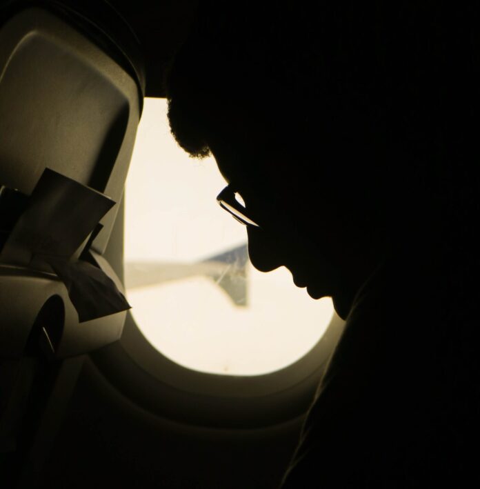 Man sitting in plane seat