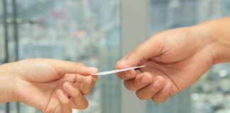 Two hands holding a credit card