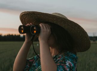 Norwegian woman looking through binoculars.
