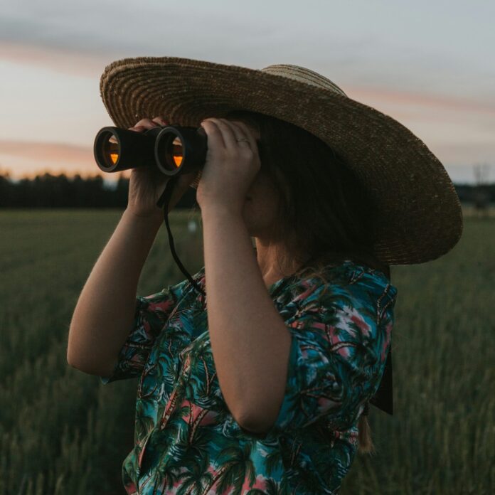 Norwegian woman looking through binoculars.